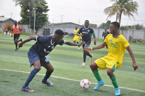 Nigerian Ports Authority (NPA) Koko Marines top striker Charles Shadrack tries to dribble past a Nigerian Navy player during the final of the Maritime Cup in Lagos on Friday.