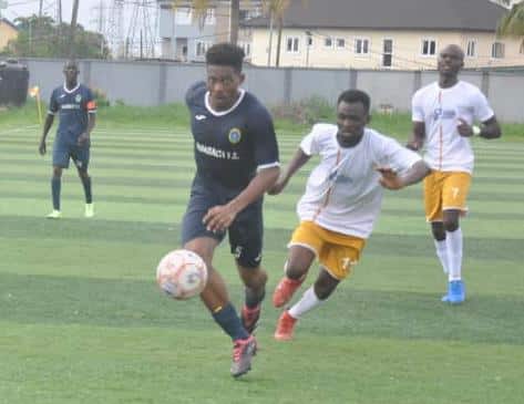 A Nigerian Navy player dribbles past Truck Transit Park (TTP) players during their group match on Monday.