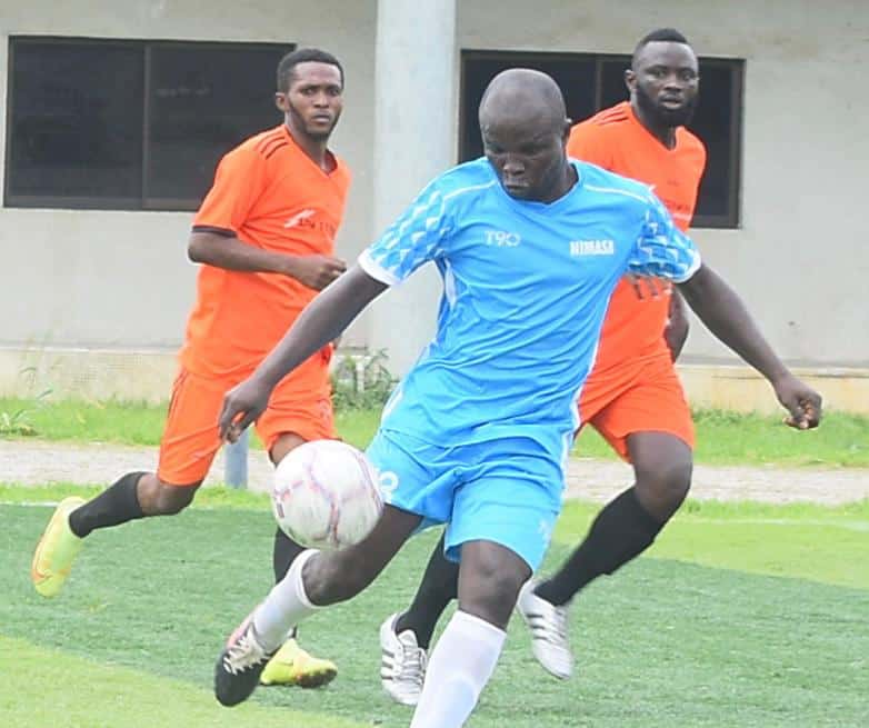 A player of the Nigerian Maritime Administration and Safety Agency (NIMASA) with two APM Terminals Apapa players.